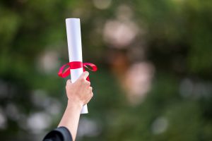 back-view-female-graduate-with-university-degree-holding-diploma-min Degree
