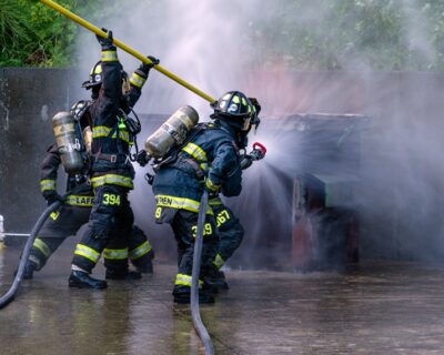 rear-view-firefighter-using-water-hose Fire Watchman Safety Course (FWSC)